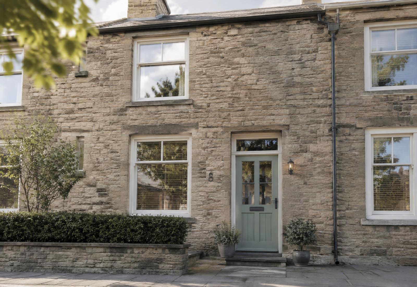 Yorkshire stone terraced house with sage green front door